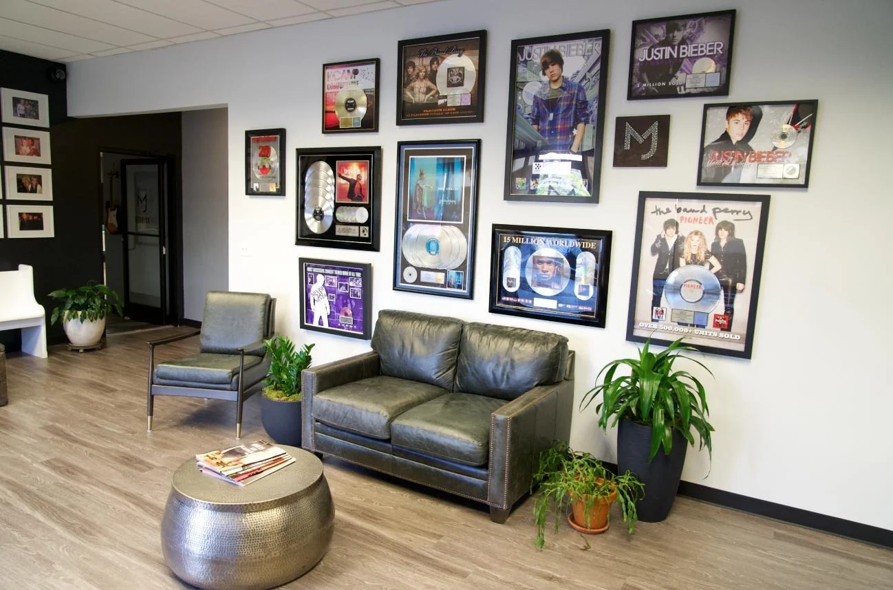ImageMil's Atlanta studio lobby with framed music awards and production memorabilia